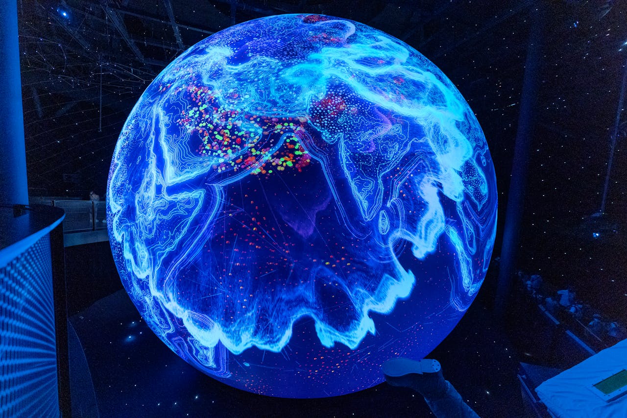 A vibrant illuminated globe display showcasing technological advancements at a science museum.